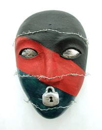A red and black mask with a lock over the lips and razor wire wrapped around the face. One of the masks created by a U.S. military service member as part of an art therapy program being analyzed by Girija Kamal, of Drexel's College of Nursing and Health Professions.