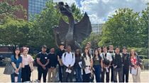 The 2025 ITA group in front of Mario the Dragon with Anne Politz, associate teaching professor in the ELC.