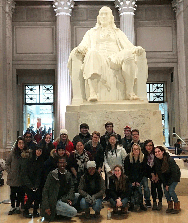 group in front of ben franklin statue