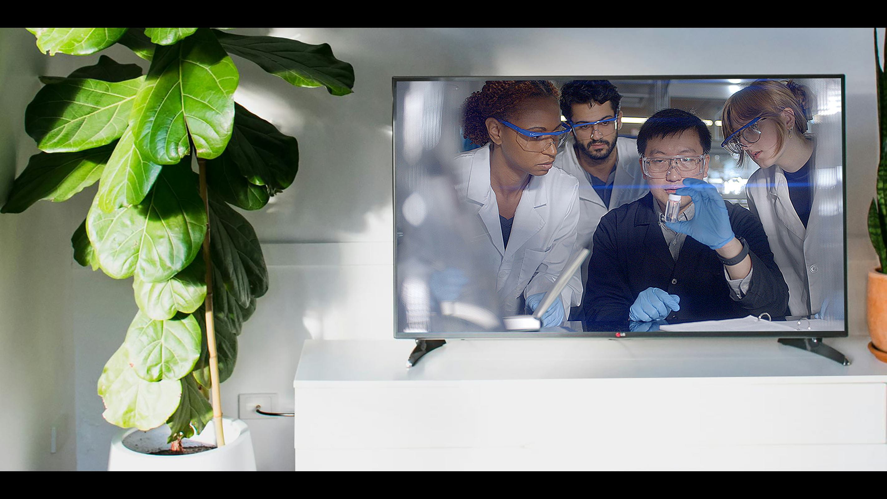 Television screen depicting Drexel students in a laboratory setting