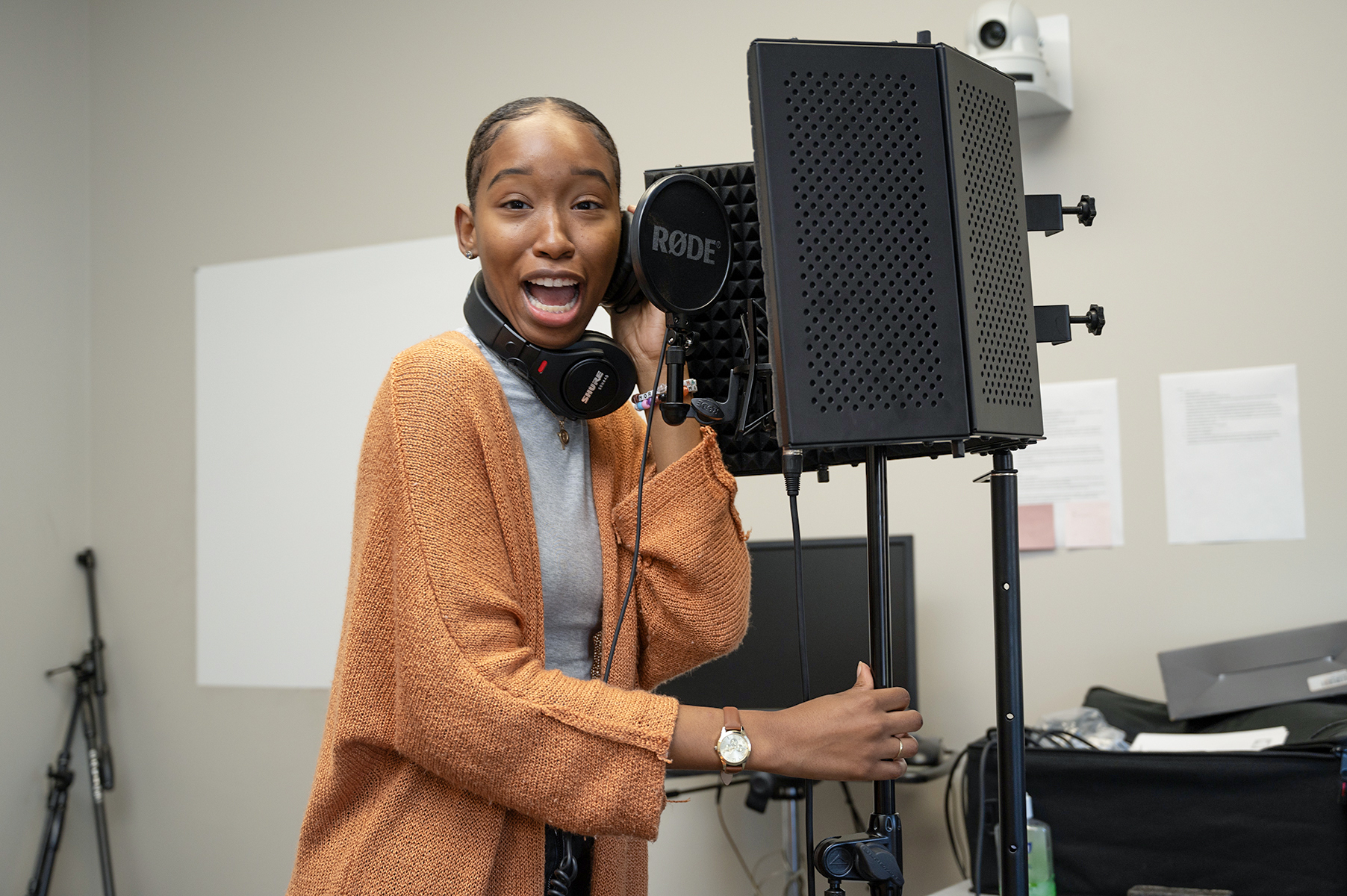 student smiling near mic stand