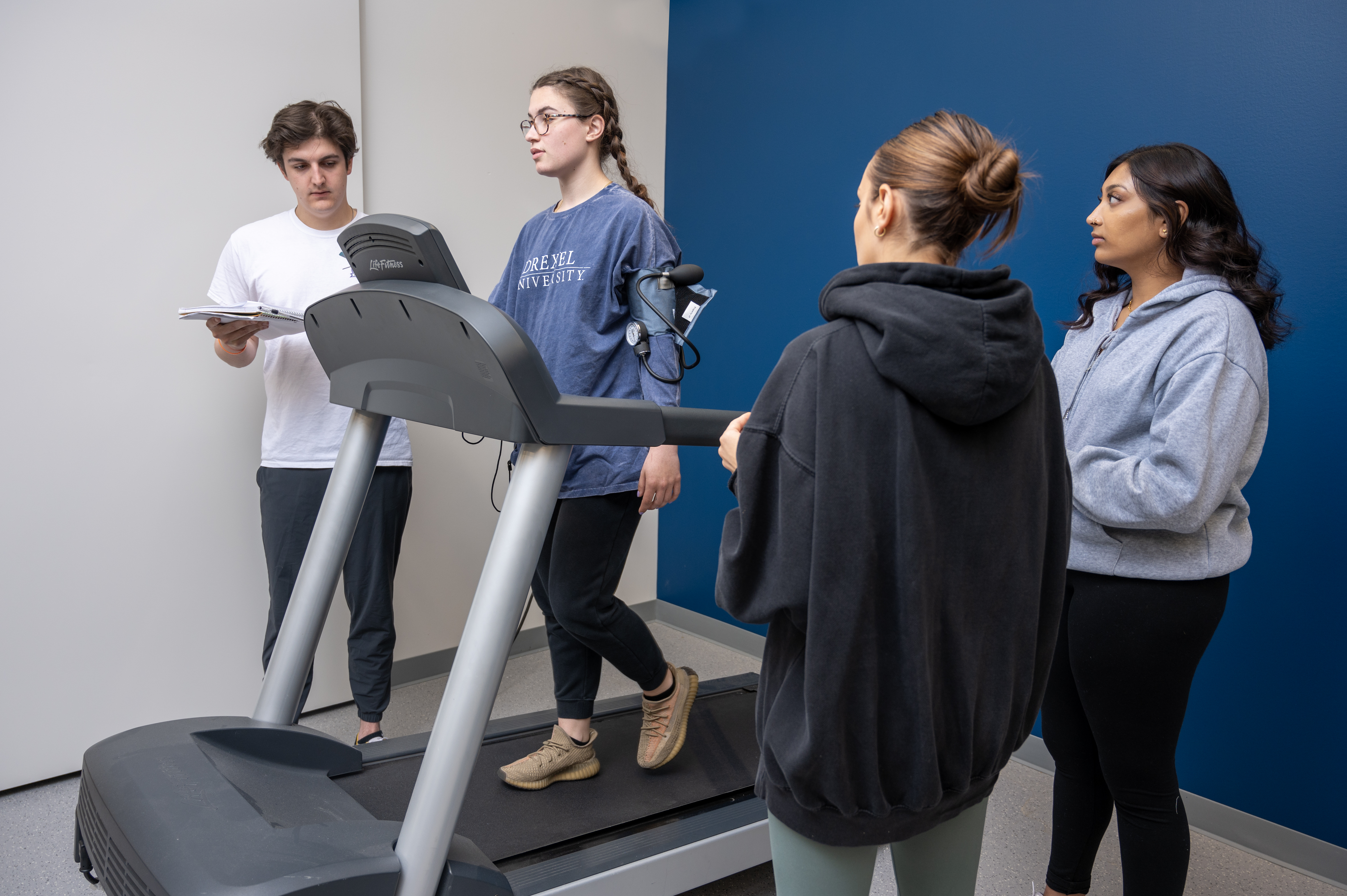 students observe student on treadmill