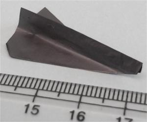 Paper plane shape made out of MXene-polymer nanocomposite with a ruler for scale
