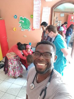 Drexel medical student Richard Smith in Quetzaltenango, Guatemala: Nutrition Clinic Selfie (local mother and child assisted by resident and 2 medical students)