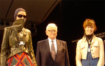 Pictured: Pierre Cardin, President of the Fashion Jury with Megan Stein and her model on the runway of the Carrousel du Louvre.