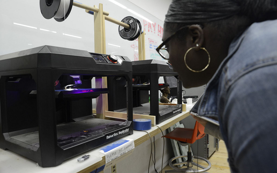 Student working on 3D printer in Hybrid Making Lab
