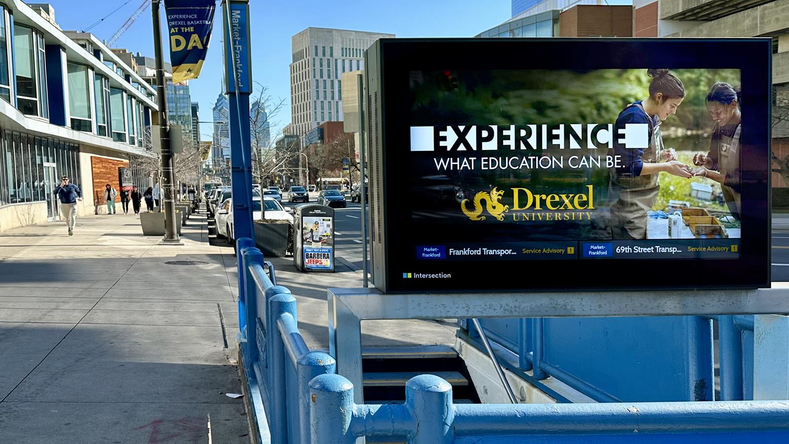 A Drexel Experience Education ad on a SEPTA subway entrance