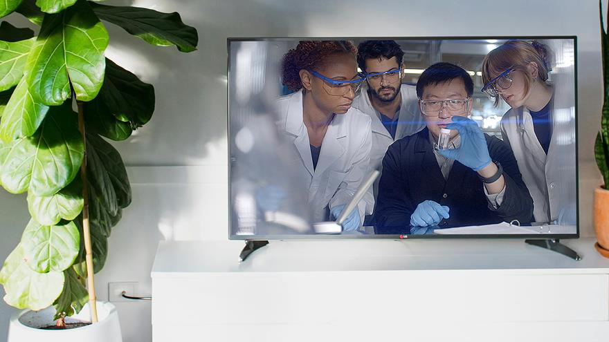 Television screen depicting Drexel students in a laboratory setting
