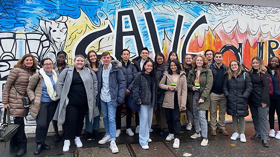 Students standing in front of mural