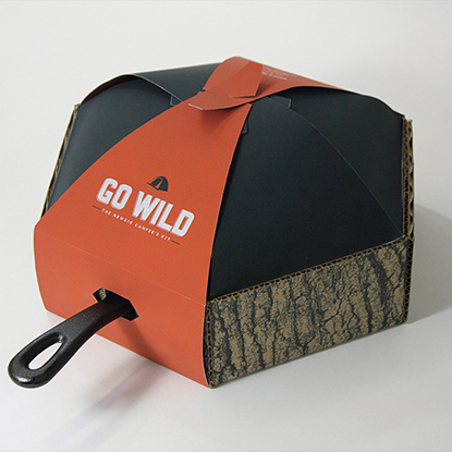 Courtney Sabo's Go Wild: A Newbie's Camper Kit packaging project with a cast iron skillet handle sticking out of the packaging